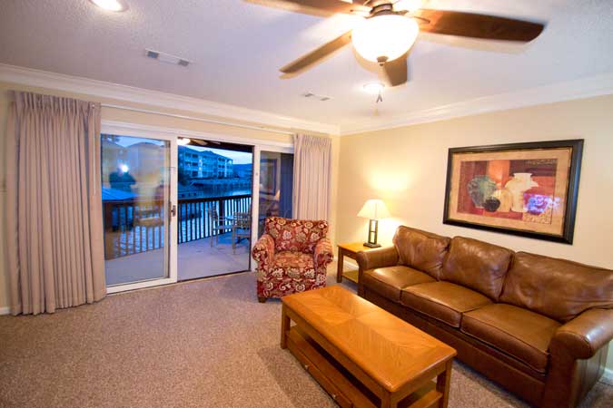 living room with adjoining balcony with lake hamilton view